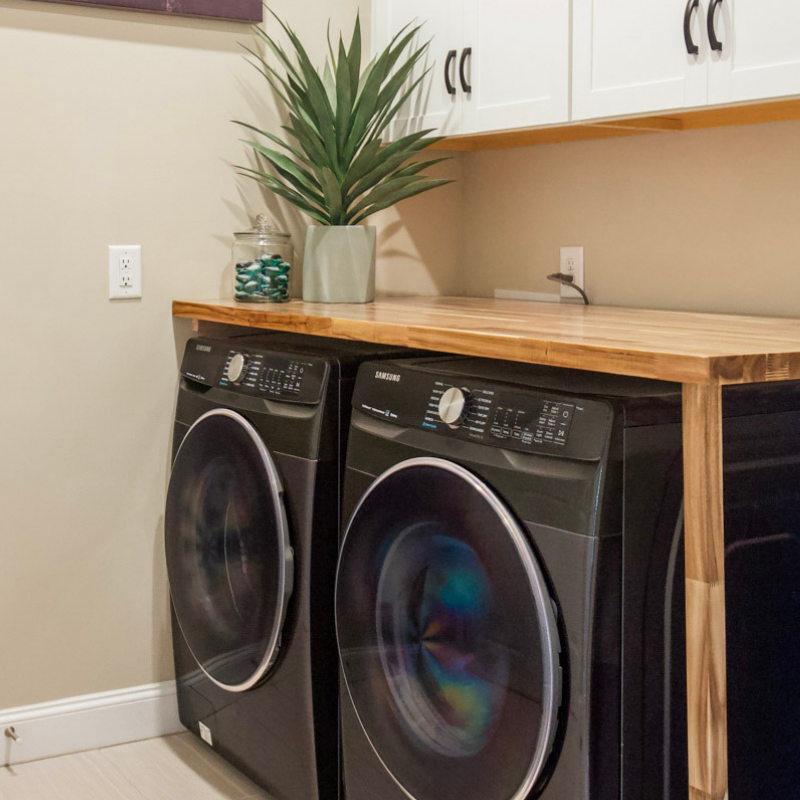 Laundry Room With Butcher Block and Cabinets